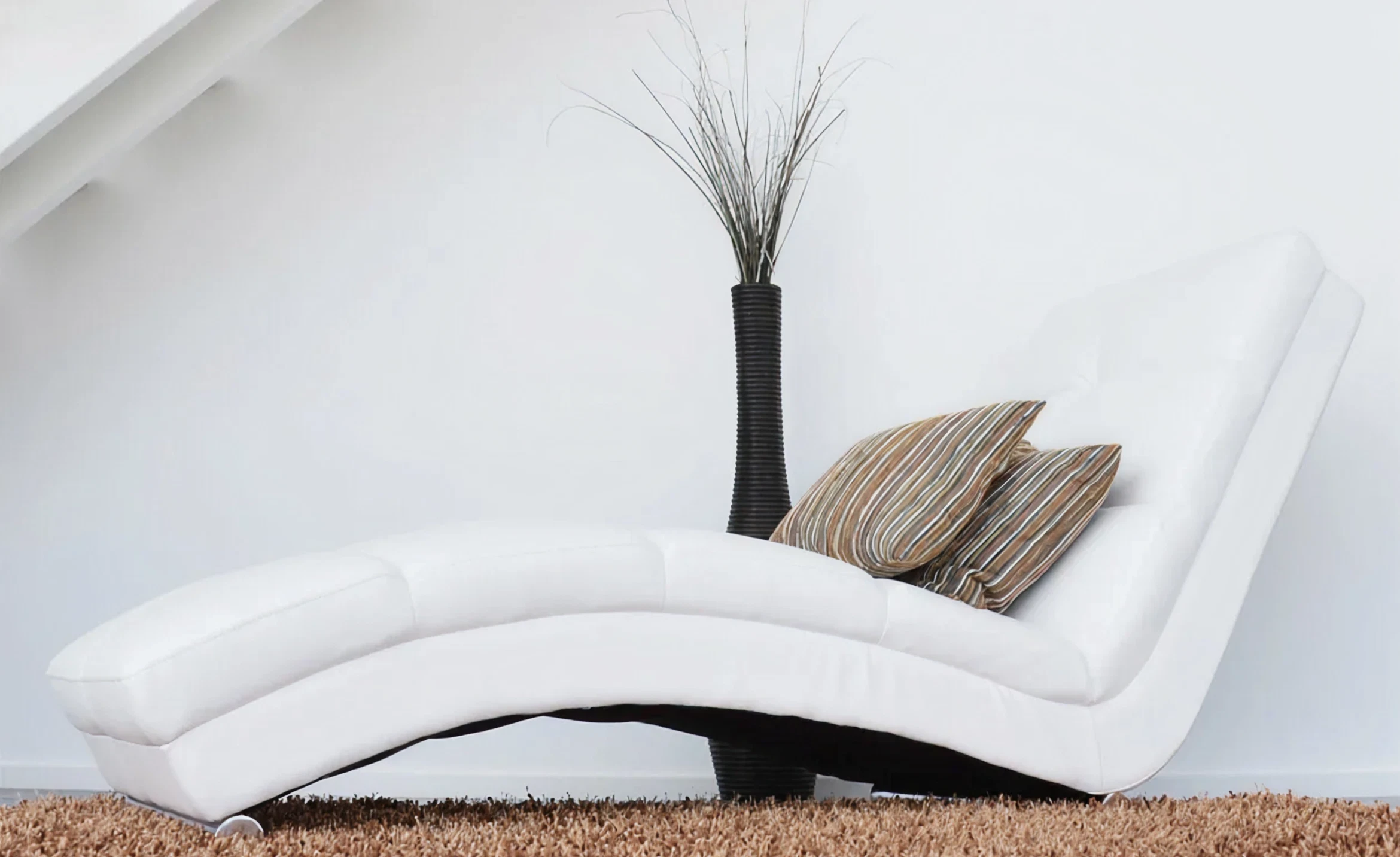 Stylish chaise lounge on brown rug